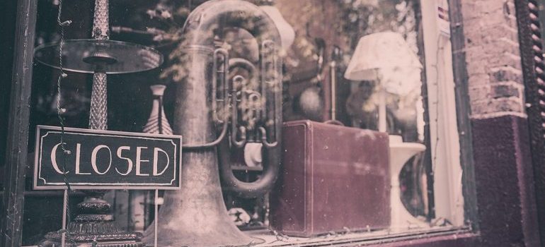 A closed sign in front of an antique store.