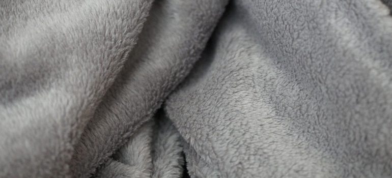 A grey blanket to use when you pack and move a flat screen TV.