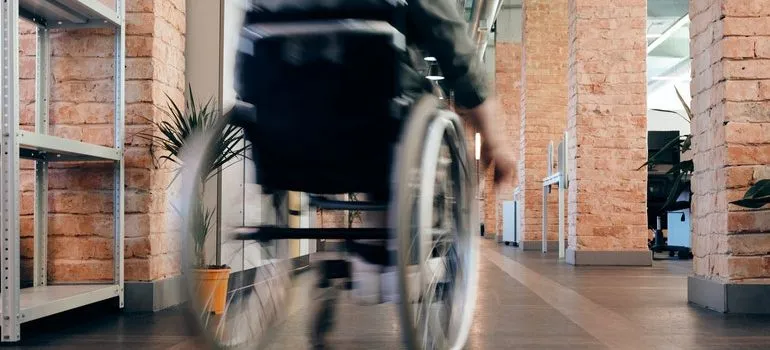 Person in a wheelchair racing down a hallway.