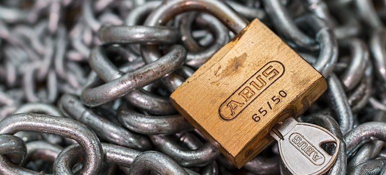 Padlock on a chain with a key inserted.