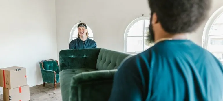 Van line affiliated movers carrying a couch