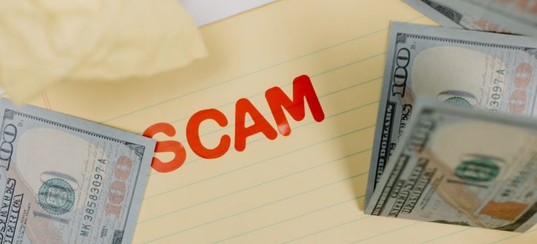 Scam written on paper