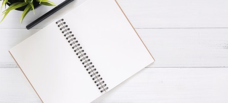 Notebook and pen you need to write down Moving tips for people with disabilities.