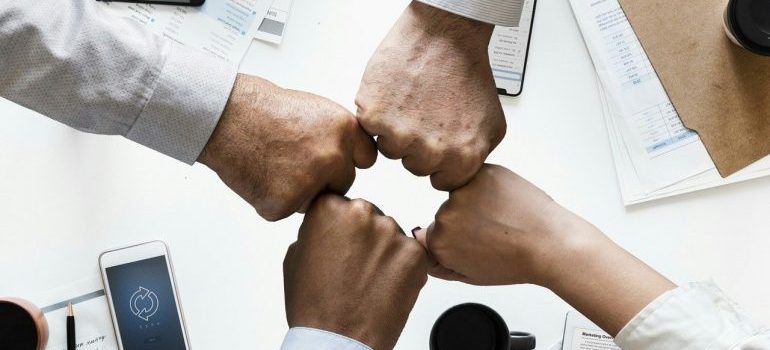 A group of people bumping hands.