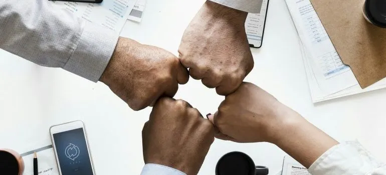 A group of people bumping hands.