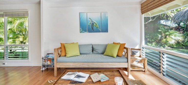 A living room with a painting of turtle on the wall.