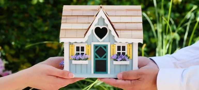 Couple holding a tiny home model