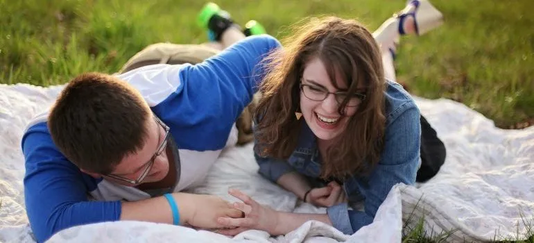 Couple laying on white mat