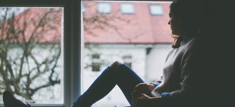 A woman sitting by the window.