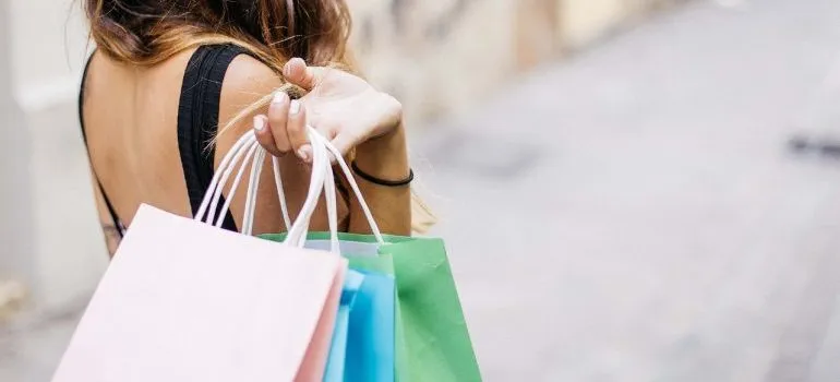A woman going shopping - a bad way to avoid clutter after moving.