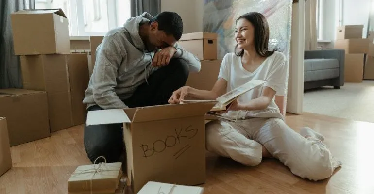 Man and woman unpacking boxes after moving.