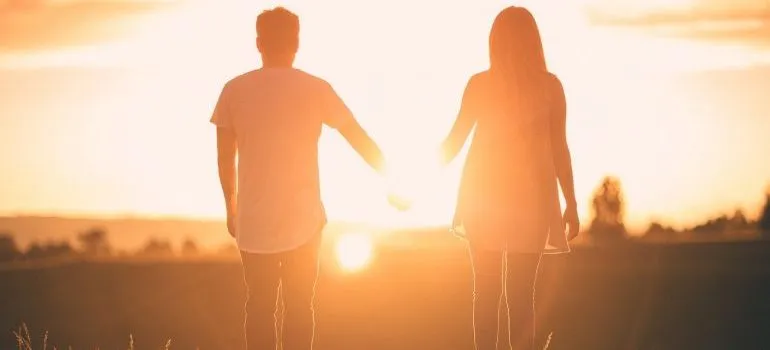 A couple holding hands in nature after moving from Chicago to Boise.