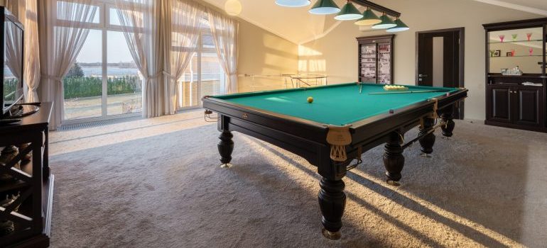 A pool table inside a room