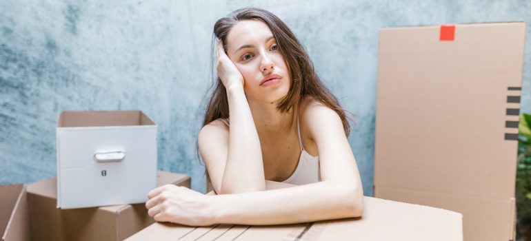 Stressed woman thinking how to avoid property damage while moving