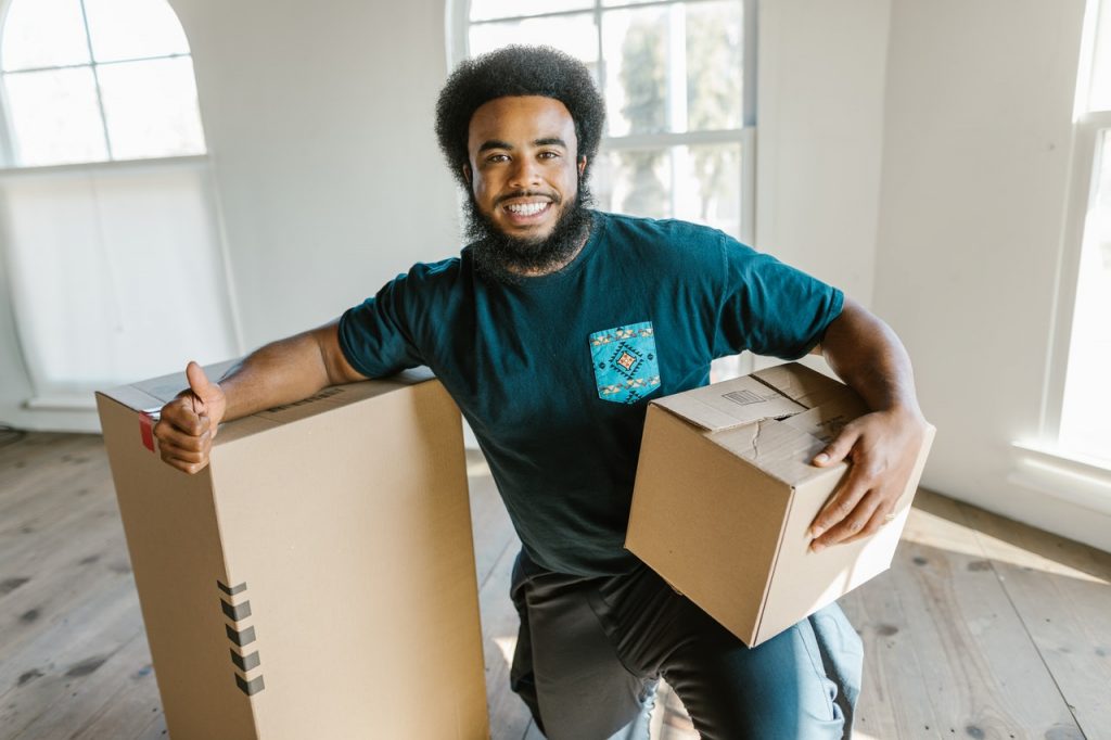 a man holding boxes is one of the reasons to get professional packing services