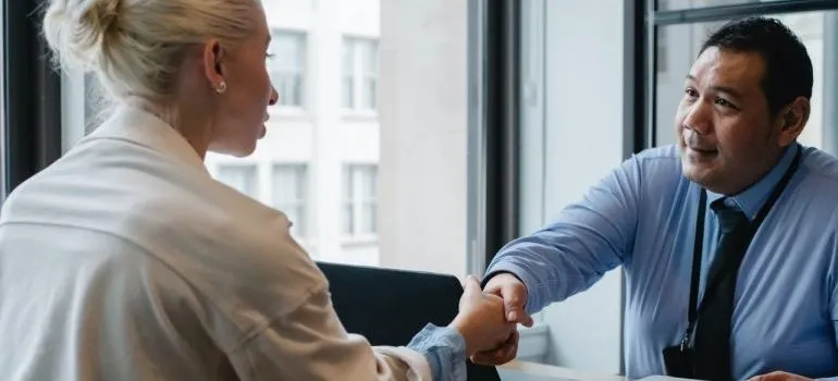 Woman meeting with mover to check moving company credibility