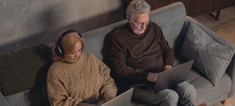 An elderly couple researching for a move.