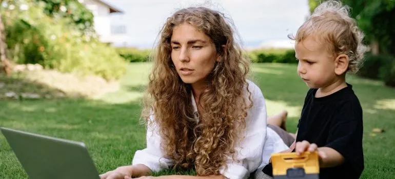 Woman using laptop to find out how to make moving for work easier on her family.