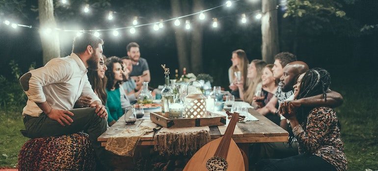 friends in a garden sitting at the table talking