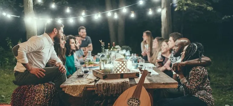 friends in a garden sitting at the table talking