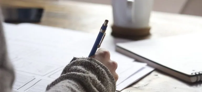 A girl making a list of the things to know when moving internationally.