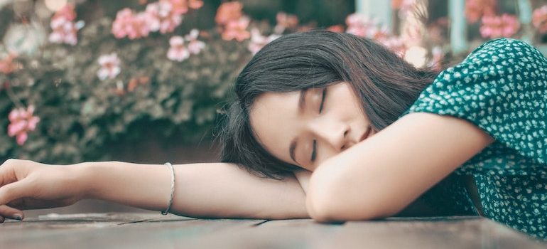 woman sleeping with her head on a table