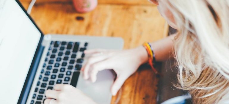 A woman working on a laptop.