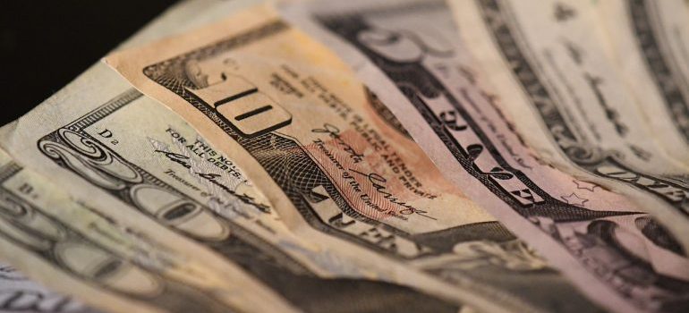 Dollar bills to pay for bills after moving from Caldwell to Nampa.