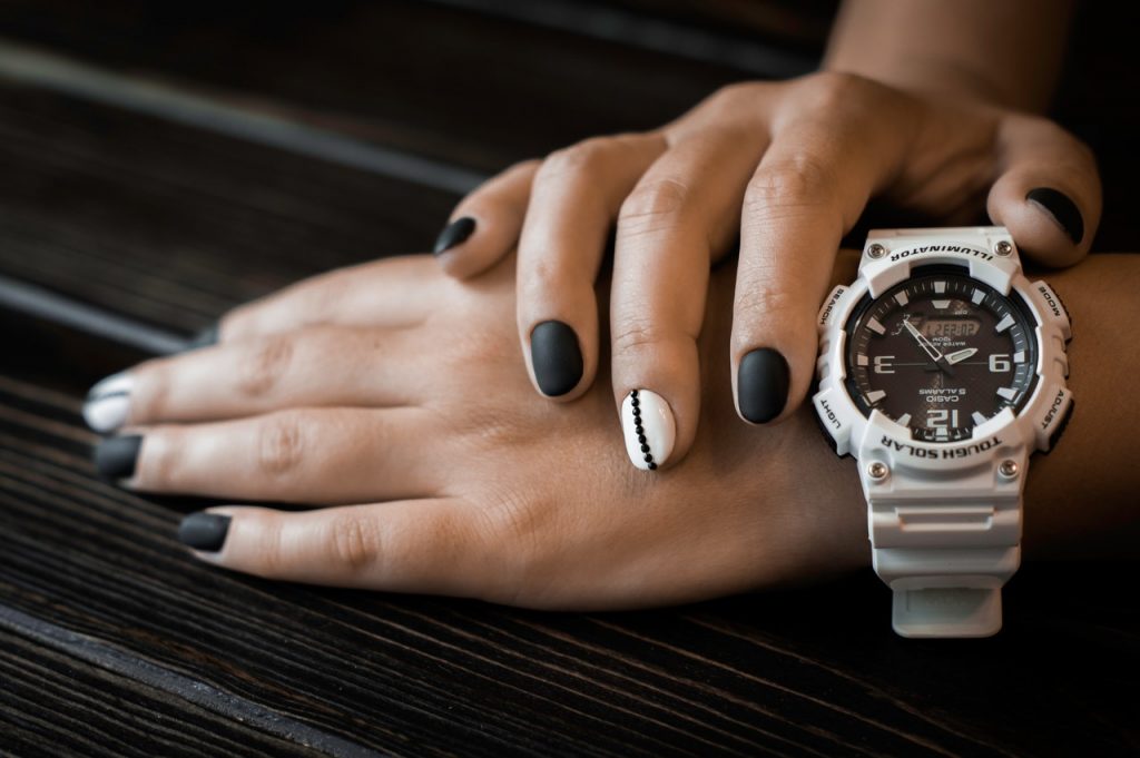 A person wearing white sports watch