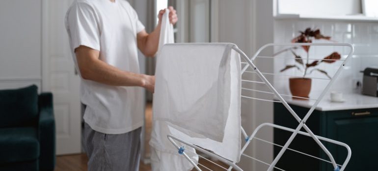 A man spreading laundry to dry