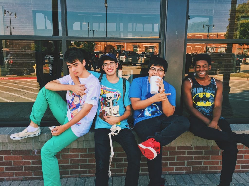 A group of teachers sitting in frint of a coffee shop.