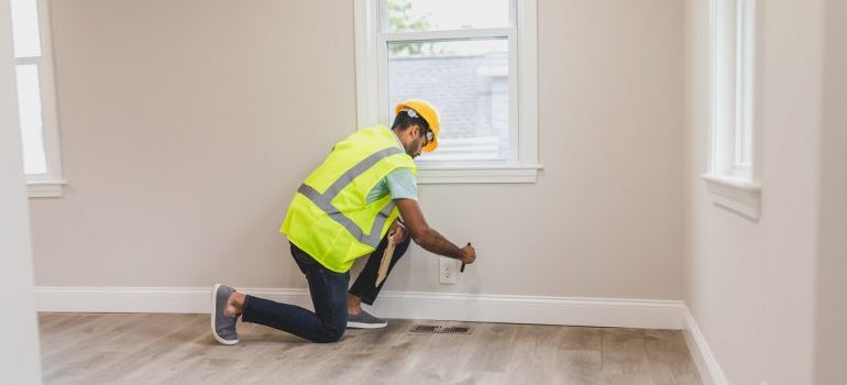 Electrician fixing an outlet in a new home.