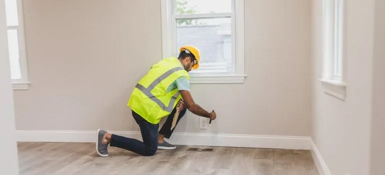 Electrician fixing an outlet in a new home.