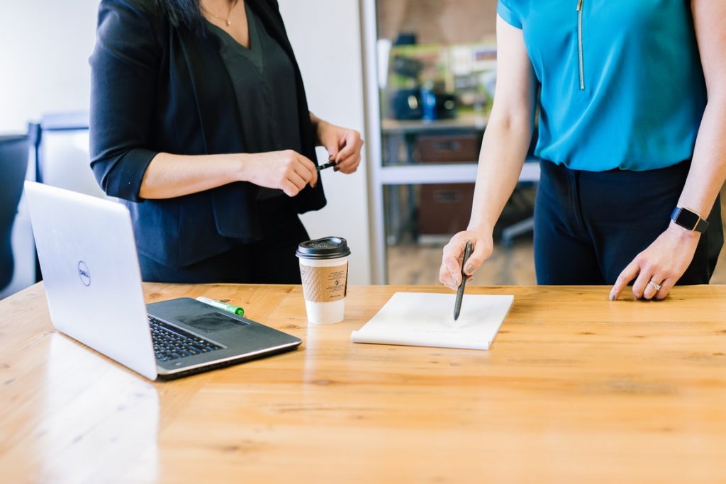 Two business people discussing a project.