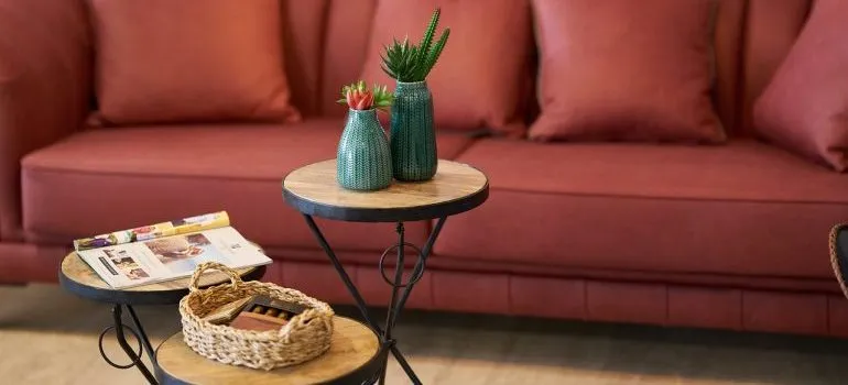 A red couch and a table in front of it.