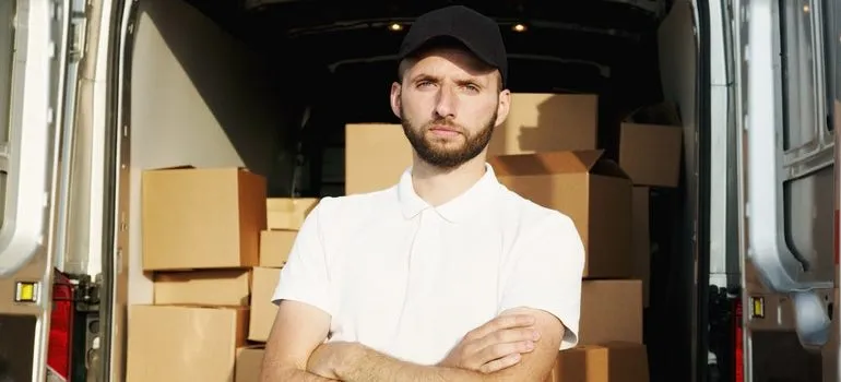 Man standing in front of a moving van.