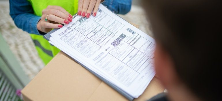 Woman signing a permit.