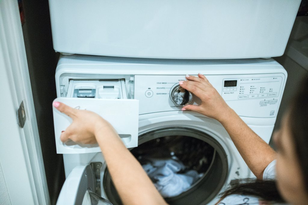 person using a washing machine