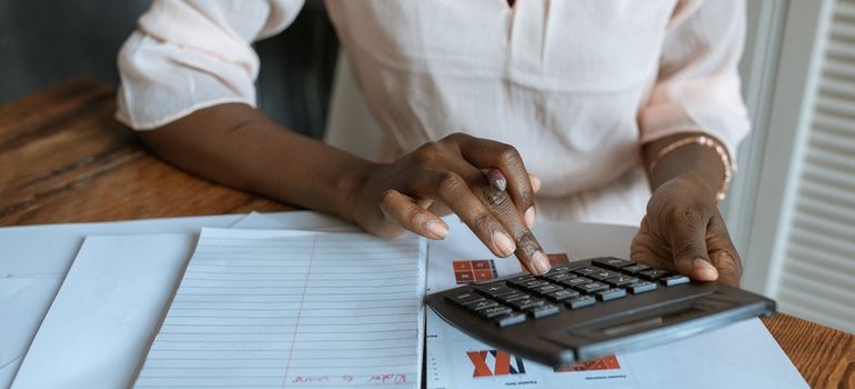 Woman avoiding moving brokerage companies by comparing moving estimates.