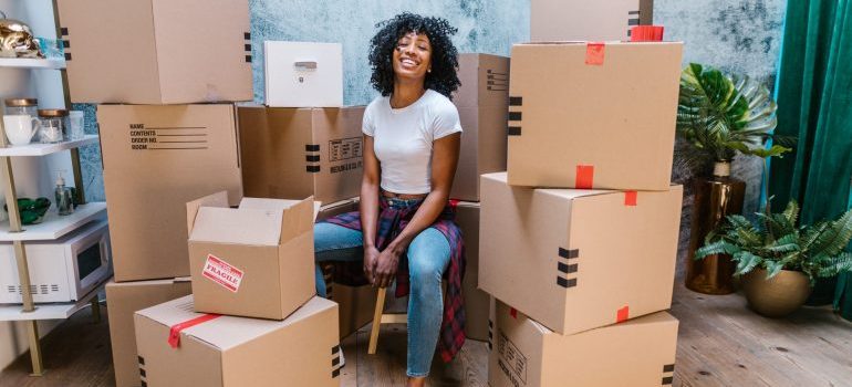 a girl sitting among boxes