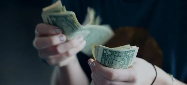person counting money for buying a fixer upper in Idaho