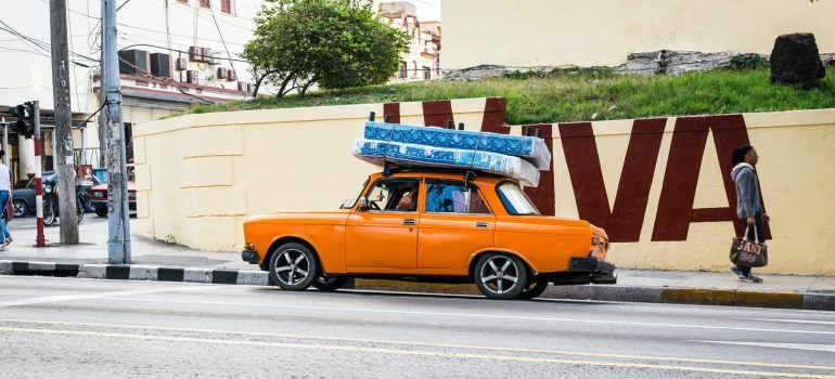 Mattresses strapped on top of a car