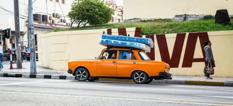 Mattresses strapped on top of a car