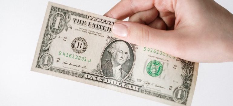 person holding a $1 bill
