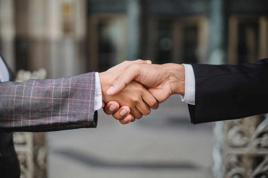 People handshaking after referring good movers to others