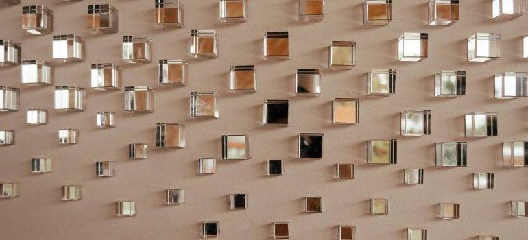 a lot of small mirrors on a wall