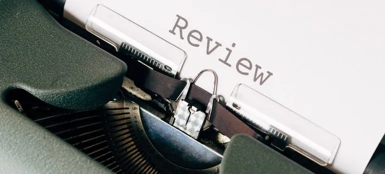 Typewriter with a paper that says "review"