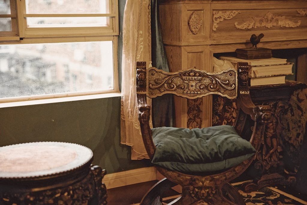 A rustic wooden chair with blue cushion