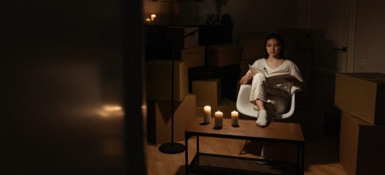 a person reading in candlelight