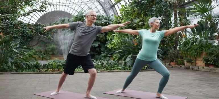 An older couple doing yoga.